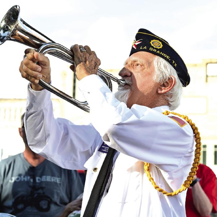 Local veteran John D. Marburger of La Grange, plays Taps during Saturday’s ceremony on the courthouse lawn. Photo by Stephanie Steinhauser