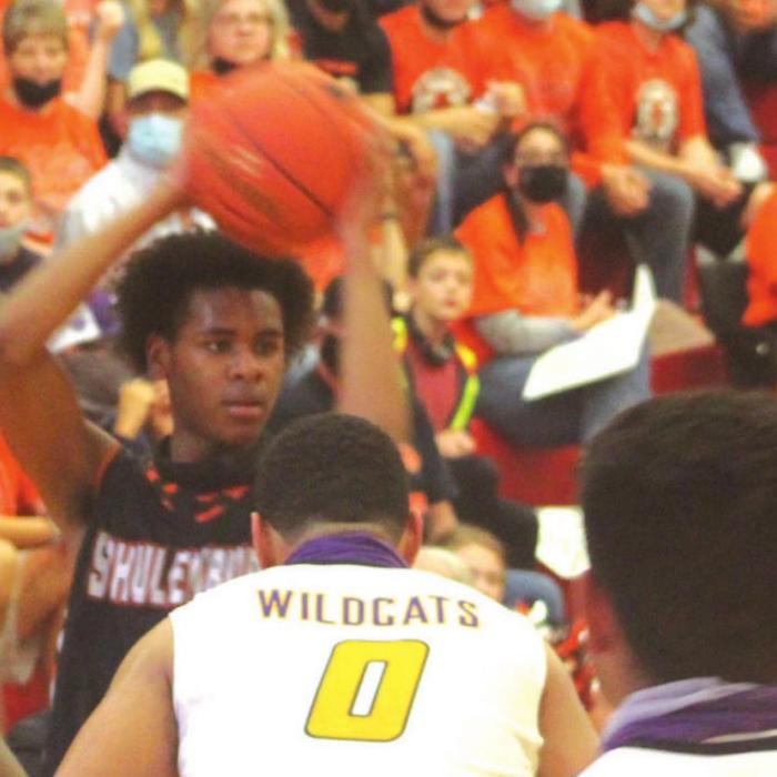 Schulenburg’s Bryce Wilson looks to make a pass Saturday, with a wall of Shorthrns fans in the background. Photo by Brian Pierson