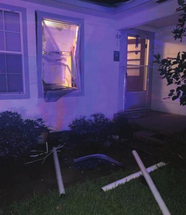 The impact snapped some of the barricade poles off at the ground and sent them flying, breaking a window of the house.