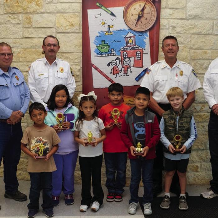 Fire poster winners and honorable mentions from first and second grade at La Grange Elementary went to (front, from left) Eilas Ramirez, Melissa Lopez, Damian Martinez, (middle) Alissa Romero, Jose Torres and Sutton Mozisek. They are pictured with (back) Kenneth Chovanec, Glen Knigge, Frank Menefee, and Todd Johnson of the La Grange Volunteer Fire Department. Photo by Andy Behlen