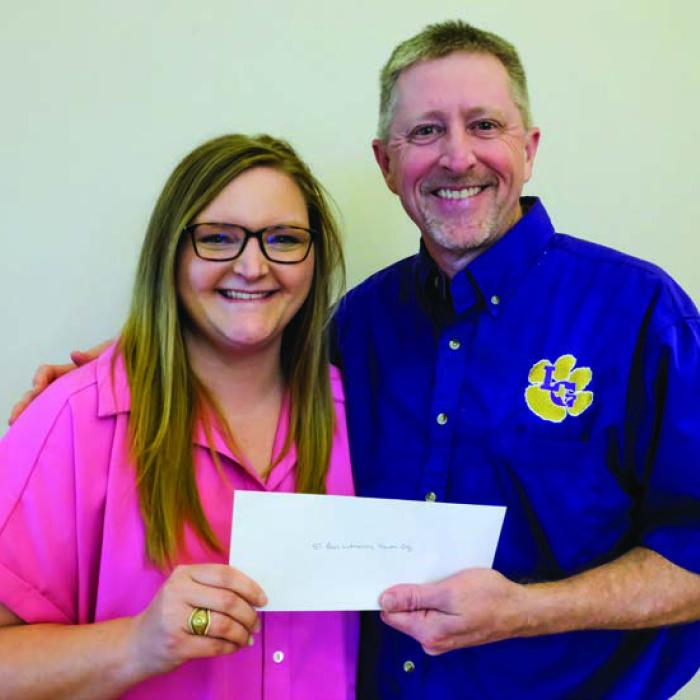 St. Paul Lutheran Youth Organization received a $2,000 grant from the Texas Women’s League. Pictured are Kristen Vandever of TWL (left) and Bradley Loehr of St. Paul LYO.