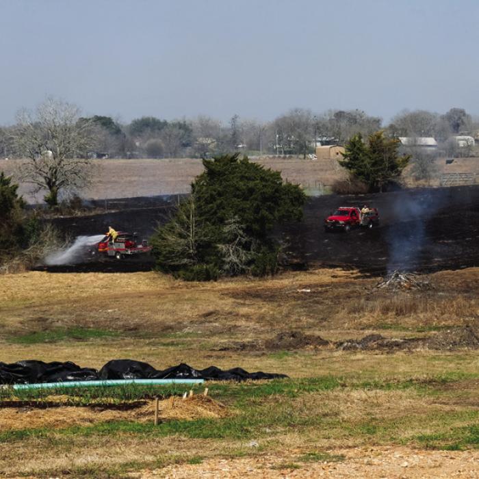 A grass fire burned about three quarters of an acre off Ruether Rd. near Rutersville Monday, Feb. 17. The La Grange Volunteer Fire Department got the call around 11:30 a.m. The property owner told the Record he set a small brush fire that morning when the wind was still. But then a south wind picked up, which apparently blew some hot embers into a patch of dry grass. La Grange VFD responded with two grass trucks and a tanker. They put out the fire and there were no major damages. Photo by Andy Behlen
