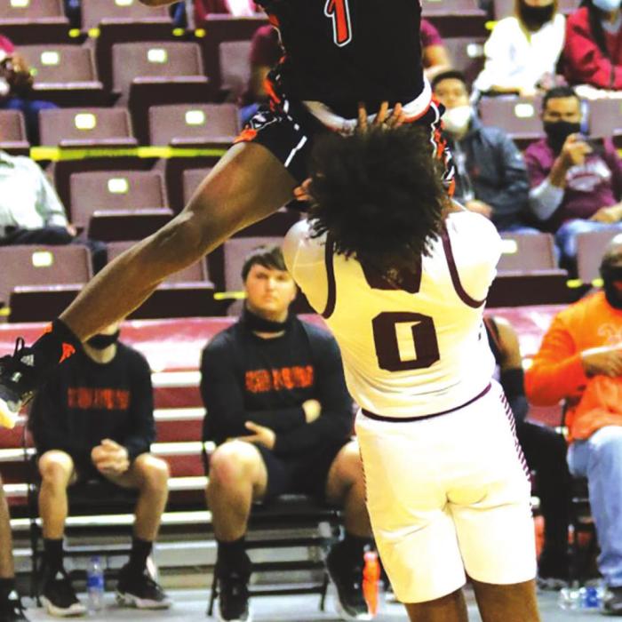 Schulenburg’s Kenny King looks as if he could hurdle over this Grapeland defender on this play Tuesday. Photo by Audrey Kristynik