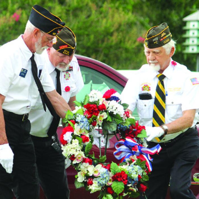 At Monday’s Memorial Day Ceremony at Koenig-Belvill Funeral Home in La Grange, members of the Marine Corps League #1028 retire the colors, left, before members of the VFW and American Legion place a memorial wreath at the flagpole. More photos on page B2. Photos by Jeff Wick
