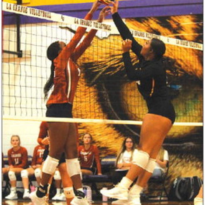 La Grange’s Cara Homer battles at the net with a Caldwell player in Tuesday’s match. Photo by Jeff Wick