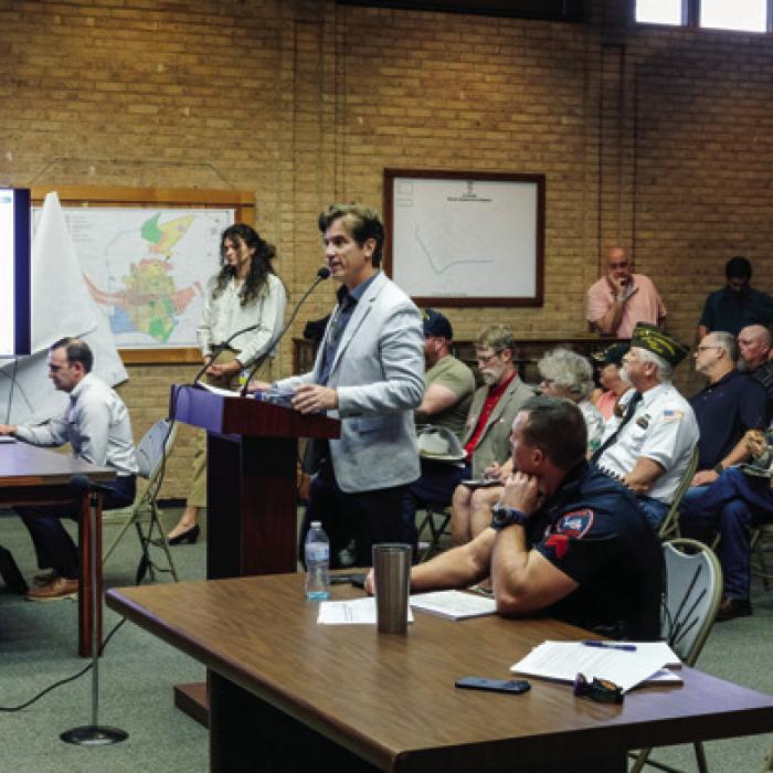 Chris Casey with the consulting firm Parkhill addressed the La Grange City Council Monday evening about proposed improvements to City Hall, the police station and Randolph Recreation Center. A big crowd filled the Council Chamber for the meeting. Some were there representing groups that use the Fayette County Fairgrounds, as the City has embarked on a master plan for future development at the Fairgrounds. Others were there to voice concerns about City spending. Photo by Andy Behlen