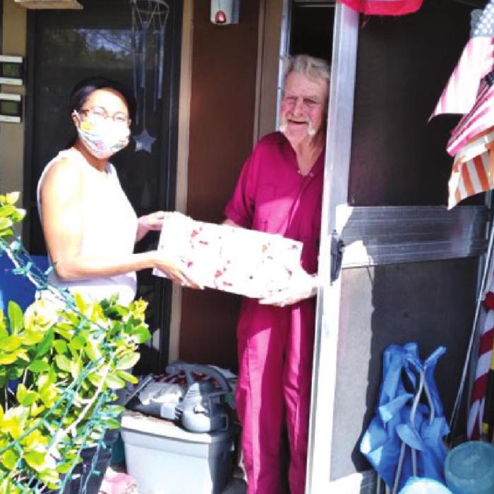 La Grange Site Manager Keisha Sanders delivering meals and gifts to county resident.