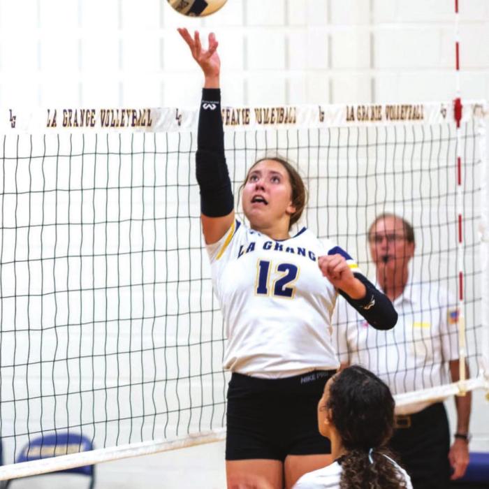 La Grange’s Maddi Fritz tips a ball over the net in Friday’s match.