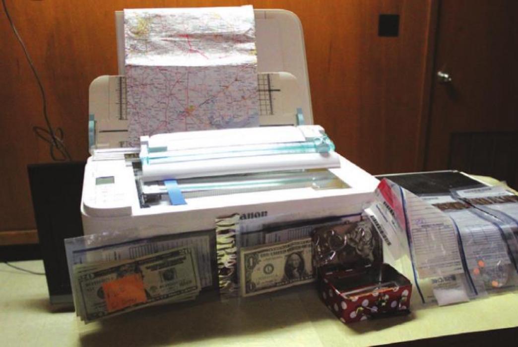 A printer, map and drugs also were seized.