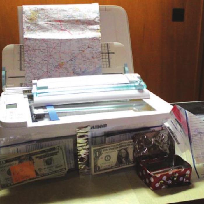 A printer, map and drugs also were seized.