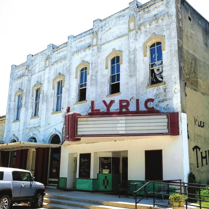 A picture of silent movie star Charlie Chaplin hangs in the window above the Lyric Theater marquee. Artists and couple Terry Ehler and John Knotts purchased the building in downtown Flatonia last Friday. Photos by Andy Behlen