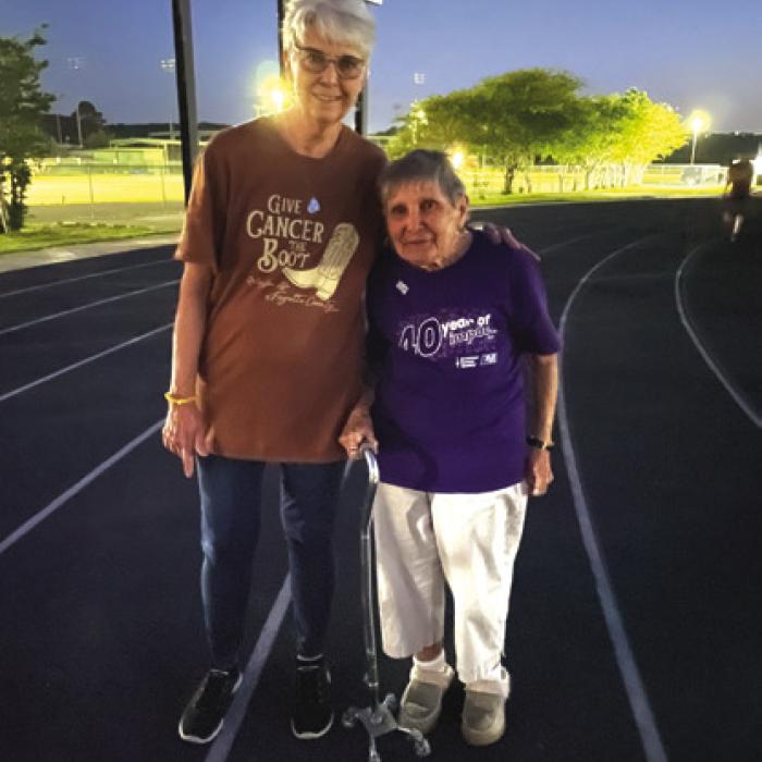 Cancer survivor Christie Webber, right, is shown walking laps with Noreen Dopslauf. Christie is 88 and still participates in the local Relay event. Photo by Eileen Behrens