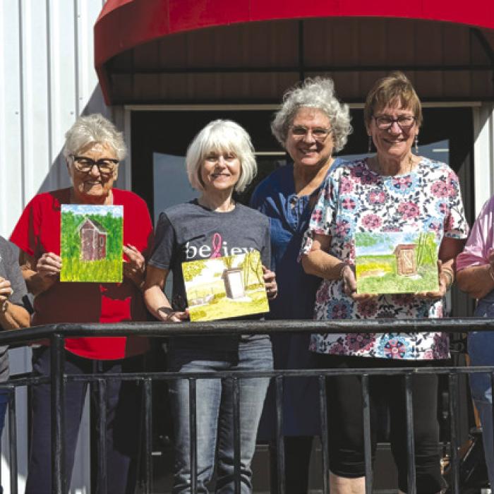 Artful Friday students Deborah Jones, Betty Mulholland, Sandy True, Kim Penland, Teacher Sue Pape, Bernie Gillings, Annette Jasek, and Irene Janda showing off their outhouse paintings from our October classes.