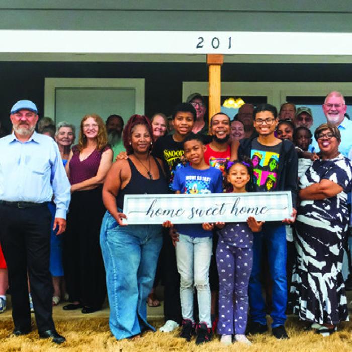Johnny Wright, surrounded by his family and volunteers from Habitat for Humanity, got the keys to his new house in La Grange’s Hope Hill neighborhood during a home-blessing ceremony on Friday, May 30. Photo by Andy Behlen