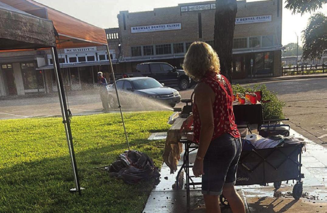 A vendor at the La Grange Farmers Market submitted this photo of the sprinklers spraying water on the courthouse lawn as vendors tried to set up for the weekly market last Saturday.
