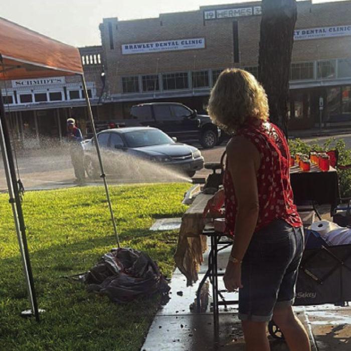 A vendor at the La Grange Farmers Market submitted this photo of the sprinklers spraying water on the courthouse lawn as vendors tried to set up for the weekly market last Saturday.