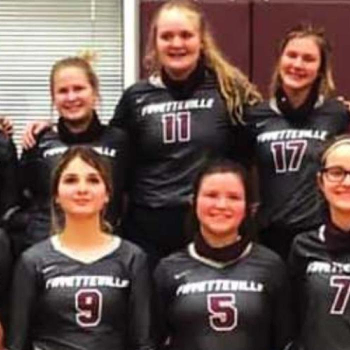 The members of the Fayetteville volleyball team celebrate their area round win Monday in Flatonia.