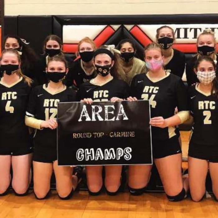 The members of the Round Top-Carmine volleyball team celebrate their area round victory Tuesday in Smithville.