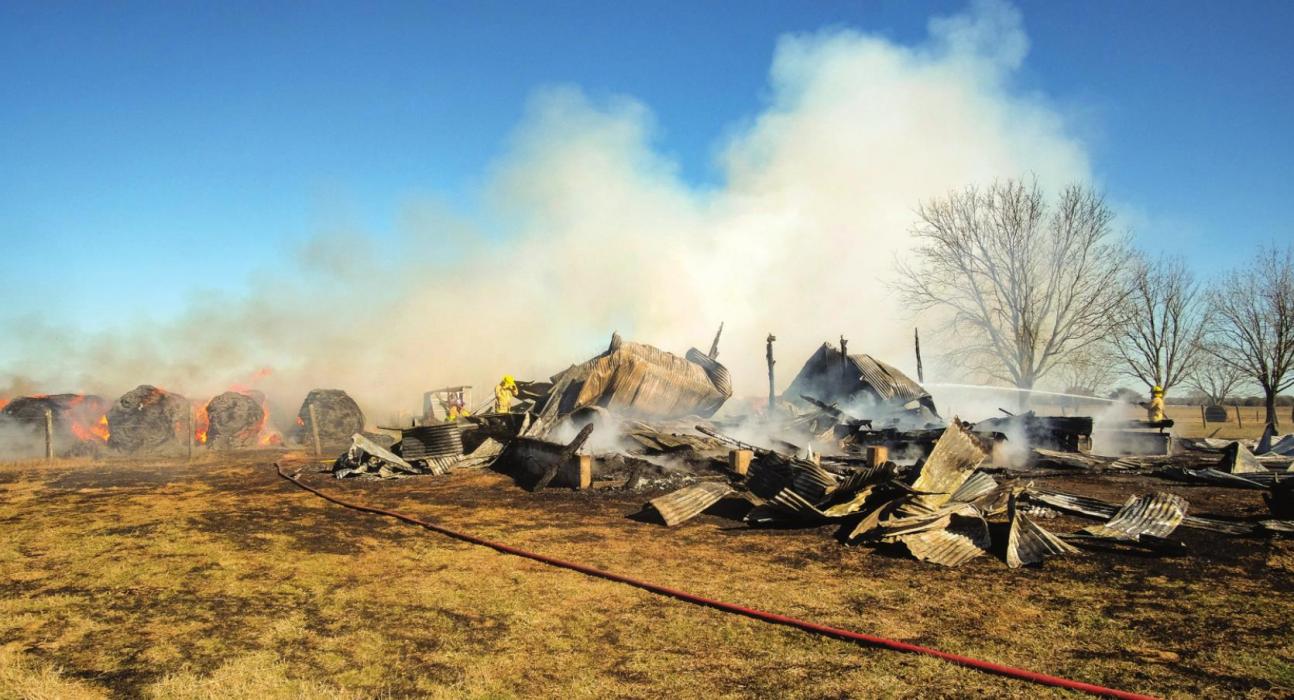 A barn near Winchester burned to the ground Monday morning. Several hay bales also caught fire. Photo by Andy Behlen