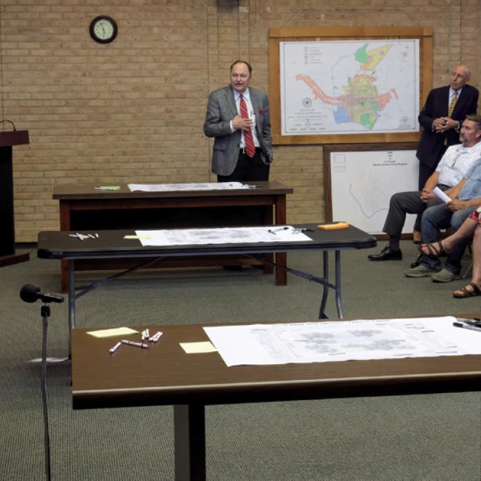 Fayette County Judge Dan Mueller (center) addresses La Grange City Manager Jack Thompson (left). Mueller said he opposes the concept for downtown, which would remove eight parking spaces around the Courthouse.