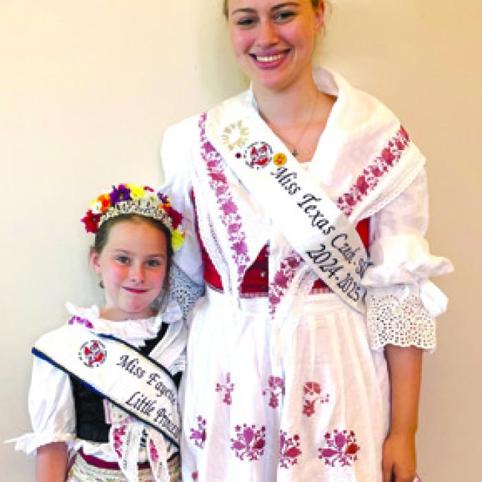 Fayette CHS Little Princess Lillie Karstedt and CHS Miss Texas Czech-Slovak Queen Madelyn Karstedt wearing Czech Krojs made by their mother, Bonny Karstedt.