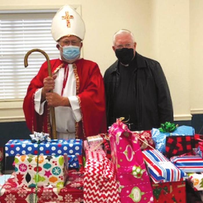 St. Nicholas with Msgr. John Peters, supporter of the St. Nicholas Ministry with gifts prepared for needy children.