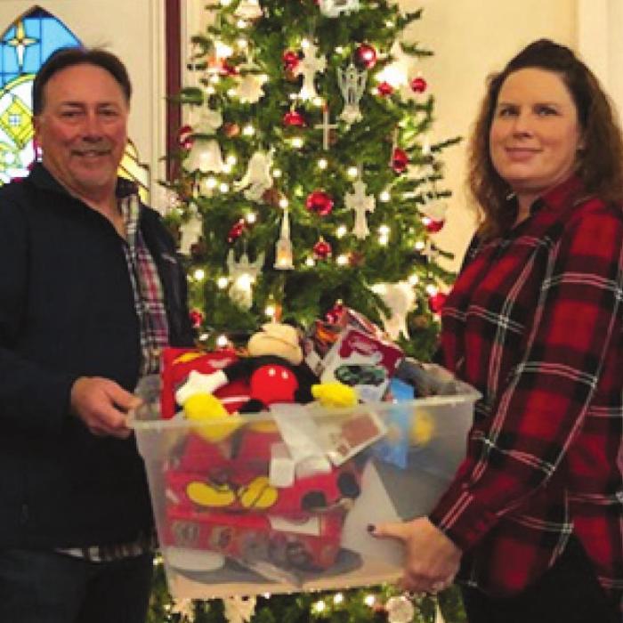 Rick and Tracy Denton presenting one of the many collection boxes of toys for needy children from the Prairie Valley/West Point congregation of St. Peter.