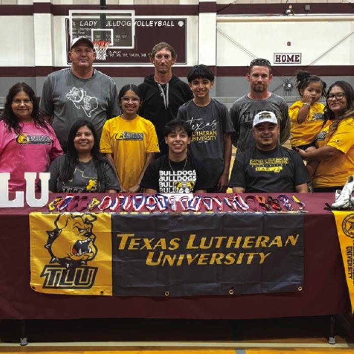 Flatonia star sprinter Luis Vela has signed a letter of intent to run track at Texas Lutheran University in Seguin. Vela is shown here at his signing ceremony front and center, along with family and coaches.