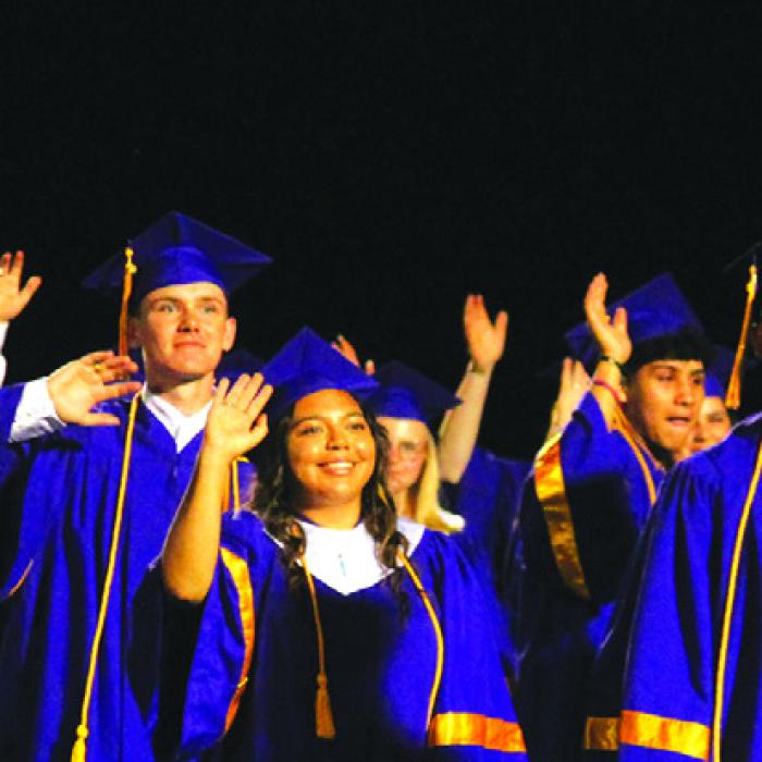 Members of the La Grange senior class wave to the crowd after they had all received their diplomas Thursday. Photo by Jeff Wick