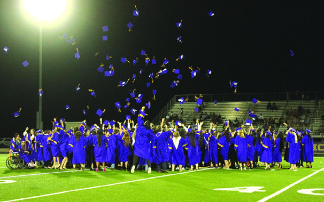 The graduates throw their caps into the air at the conclusion of Thursday’s ceremony.