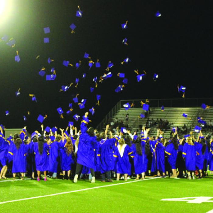 The graduates throw their caps into the air at the conclusion of Thursday’s ceremony.