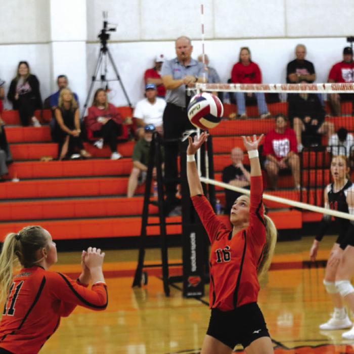 Schulenburg’s Jenna Guentert sets the ball for teammate Saybra Pinney in Tuesday’s match. Photo by Audrey Kristynik