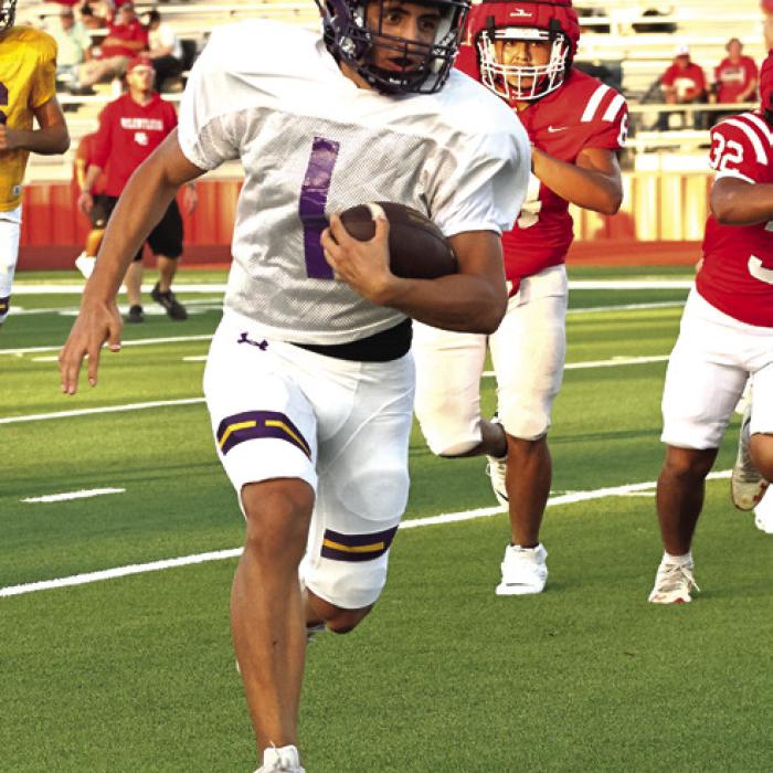 Dillan Johnson, left, and Van Hill, right, run the football in Friday’s scrimmage. Photos by Darrell D. Gest