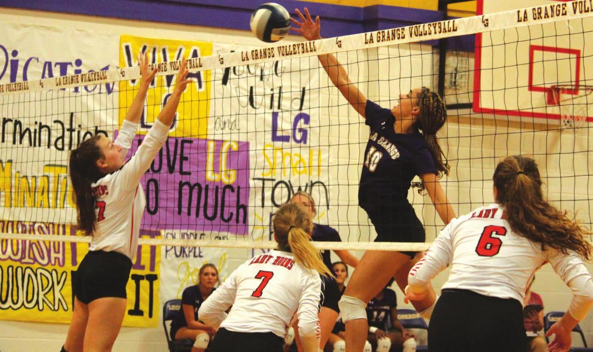 Schulenburg’s Mackenzie Kunschick goes up to the net to try to block a hit by La Grange’s Camille Gonzalez in Friday’s match. Photo by Jeff Wick