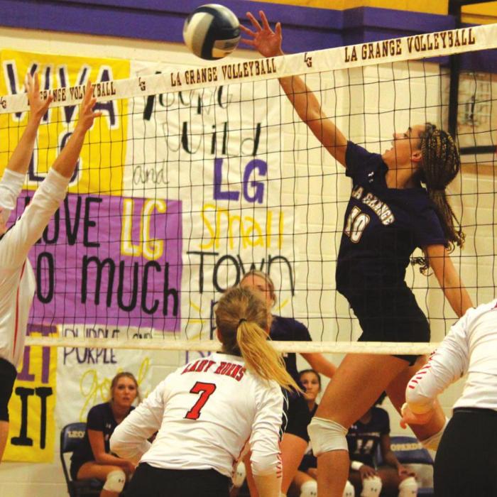 Schulenburg’s Mackenzie Kunschick goes up to the net to try to block a hit by La Grange’s Camille Gonzalez in Friday’s match. Photo by Jeff Wick