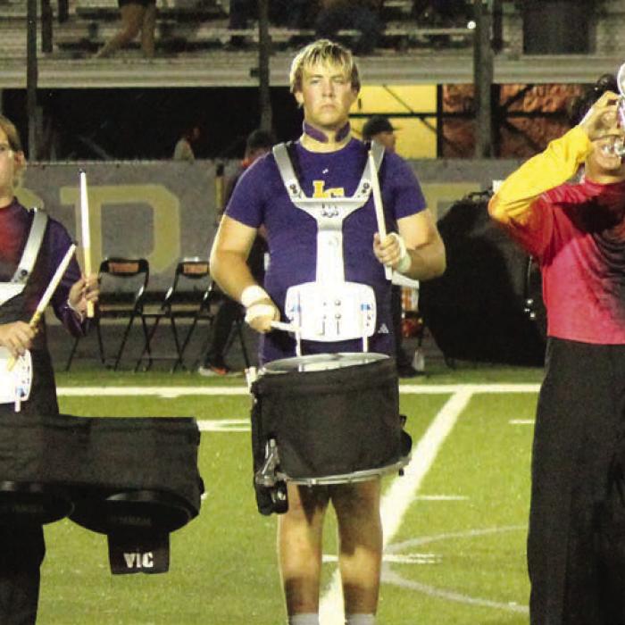 Travis Hill the Leps varsity football player, left, and Travis Hill, right, as he looks after taking off the jersey and shoulder pads and grabbing his snare drum with the Leopard Marching Band every Friday night. Photos by Jeff Wick