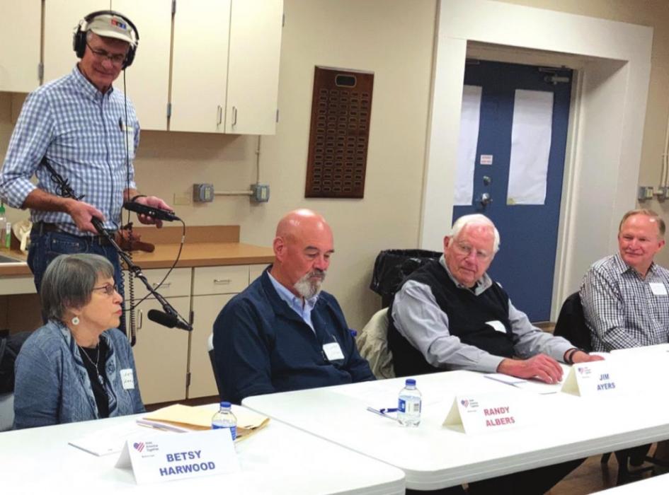 NPR reporter John Burnett records as Braver Angel participants, from left, Betsy Harwood, Randy Albers, Jim Ayers and Chuck Mazac express their views. The workshop was held Feb. 17 at Randolph Recreation Center in La Grange.