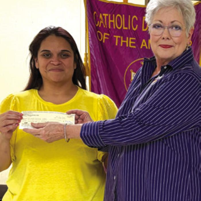 Regent Sherry Hebert presented monetary gifts for Sacred Heart Parish Vacation Bible School and the high school religious education SHOCK program to Leticia Solorzano, youth ministry coordinator.