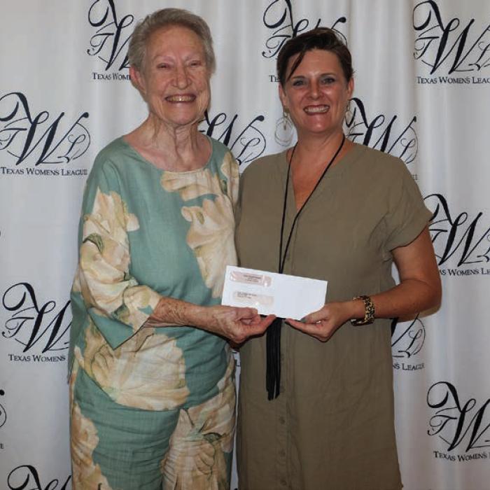 Faith Lutheran High School received a $3,700 grant. Accepting the award was Marceil Prestridge (left). Presenter was Ashley Bishop (right).