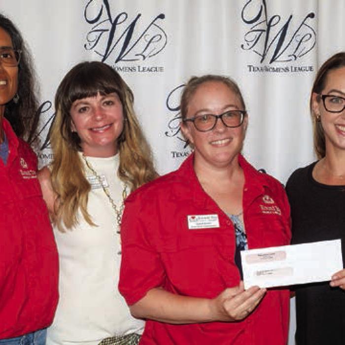 Round Top Library Association received a $3,700 donation. Accepting the award were (from left) Keelia Ritch, Ashlee Lyons and Stacie Brown. Presenter was Susannah Mikulin (right).
