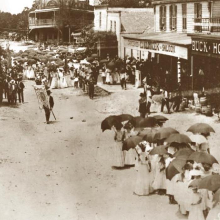 A parade in downtown Fayetteville in 1905, showing the Knesek building on the right.