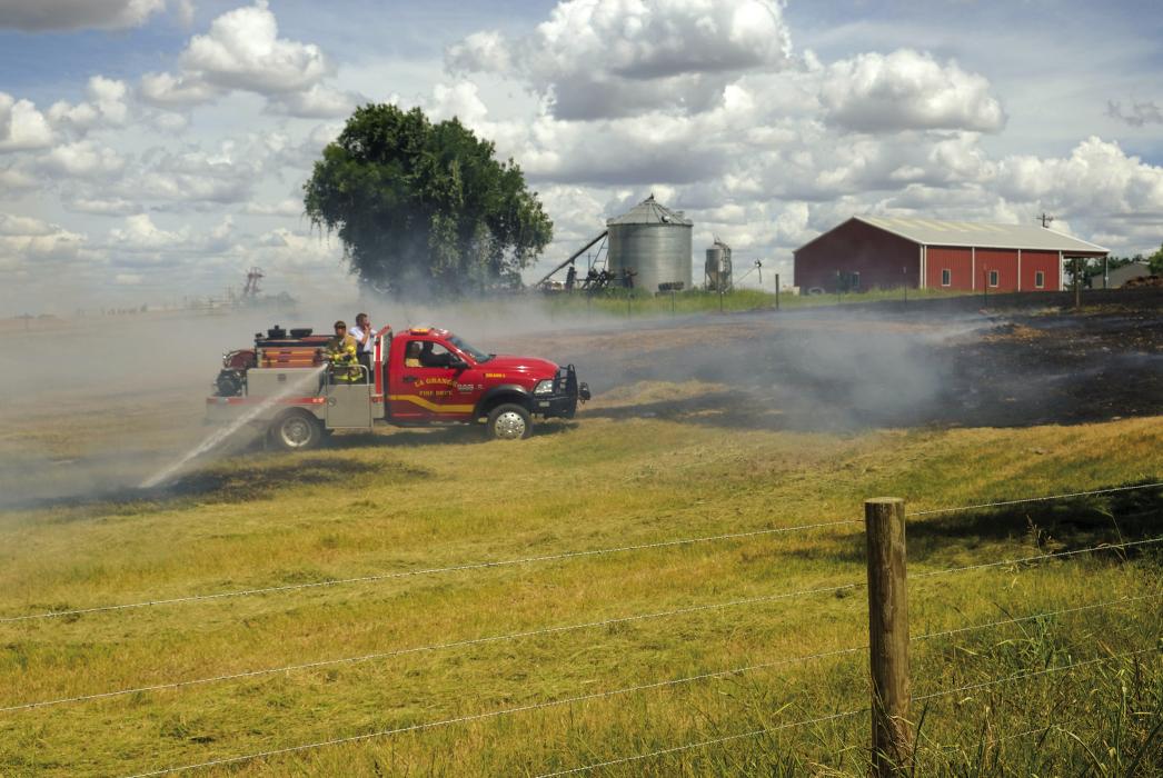 La Grange firefighters battled a grass fire on Egypt Rd. near Plum Monday, Aug. 1. Photo by Andy Behlen