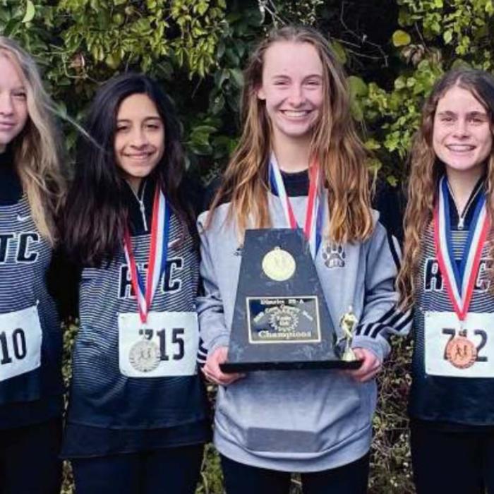 The Round Top-Carmine cross country team with their team trophy and medals.