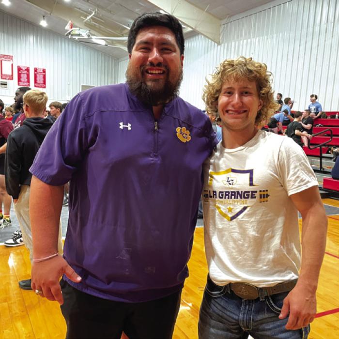 La Grange powerlifting coach Carlos Guevara, celebrates with Cody Krupala as they learned he was headed to the state meet in powerlifting.