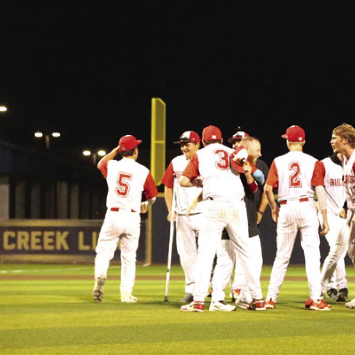 Fayetteville’s Jack Schley (7) embraces Luke Beseda, after the game’s final out, as Centerville players celebrate their 11-1 win that puts them in the state title game. Photo by Ken Sury
