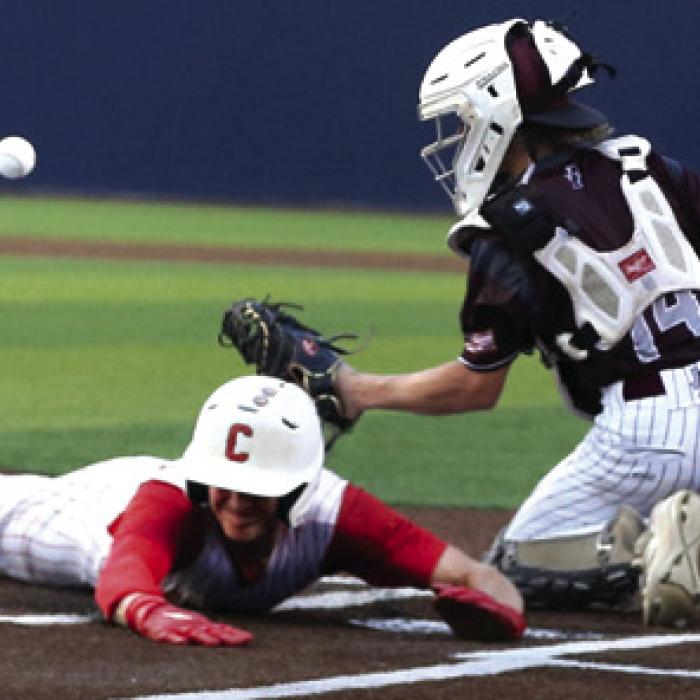 Centerville’s Drew Larsen scores as Fayetteville catcher Slade Cejka awaits the throw. Photo by Ken Sury