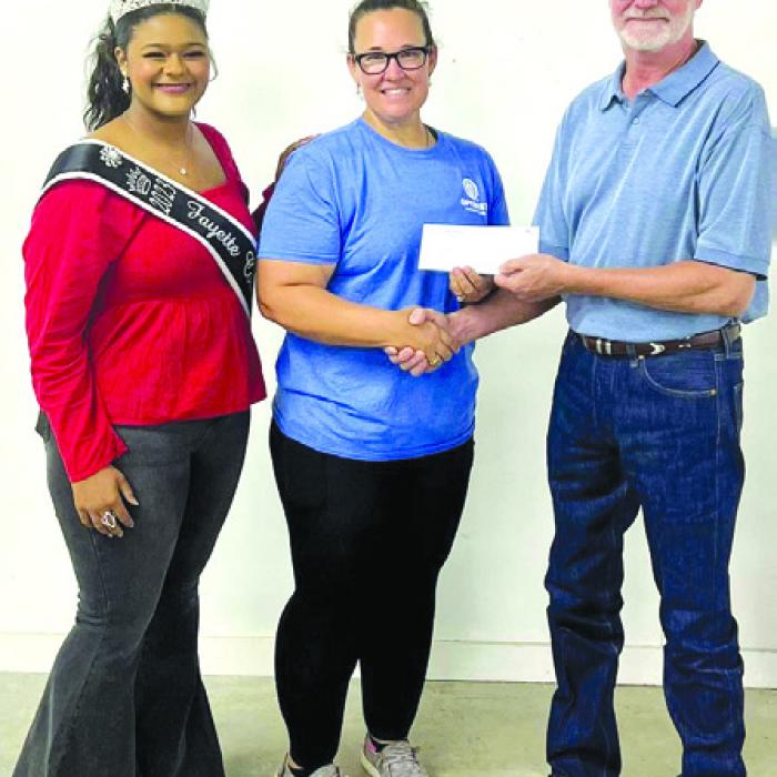 Fayette County Fair Queen Harper Henneke represented the La Grange Optimist Club who received a donation of $2,964.50. Pictured from left: Harper Henneke, Optimist representative Misty Rox and Fair President Mike Zuhn.
