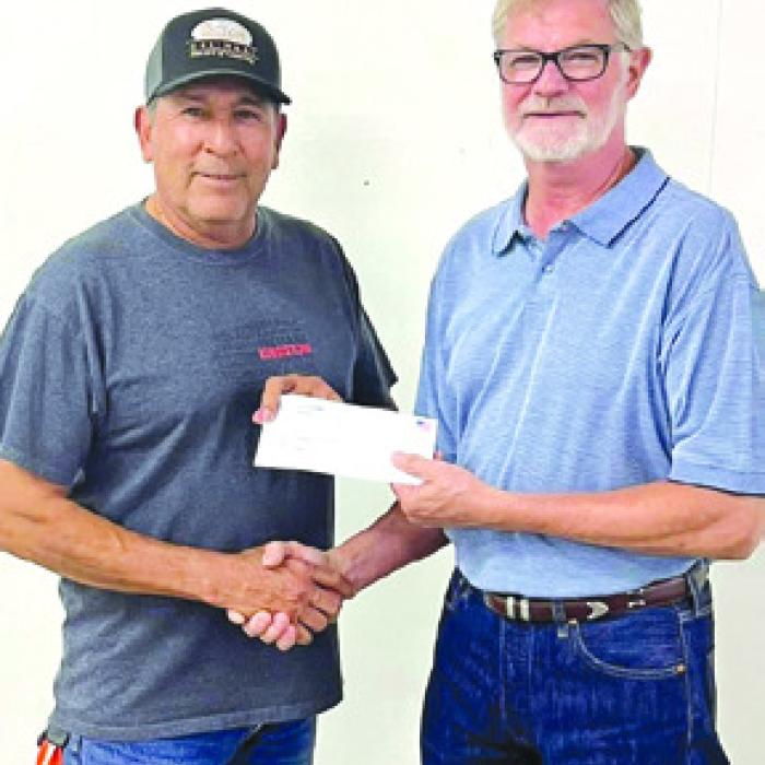 Celeine Fabre represented Knights of Columbus of La Grange who received a donation of $1,249.50. Pictured from left: KC representative Hector Cervantez and Fair President Mike Zuhn.