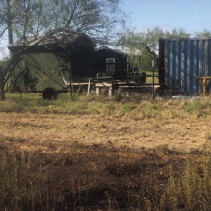 Local firefighters spent nearly five hours battling a 24-acre brush fire in the Elm Grove area Monday. The line of burned vegetation pictured above shows how close the fire got to several structures on the property. Photo courtesy of Muldoon Fire Chief Stephen Kelly