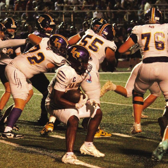 La Grange’s Dillan Johnson looks for running room behind a big group of Leopard blockers, left to right, Khris Cuevas (90), Trey Brumley (72), Jahir Lopez Ocon (55), Whitaker Samples (76) and Casen Conrad (4). Photo by Jeff Wick